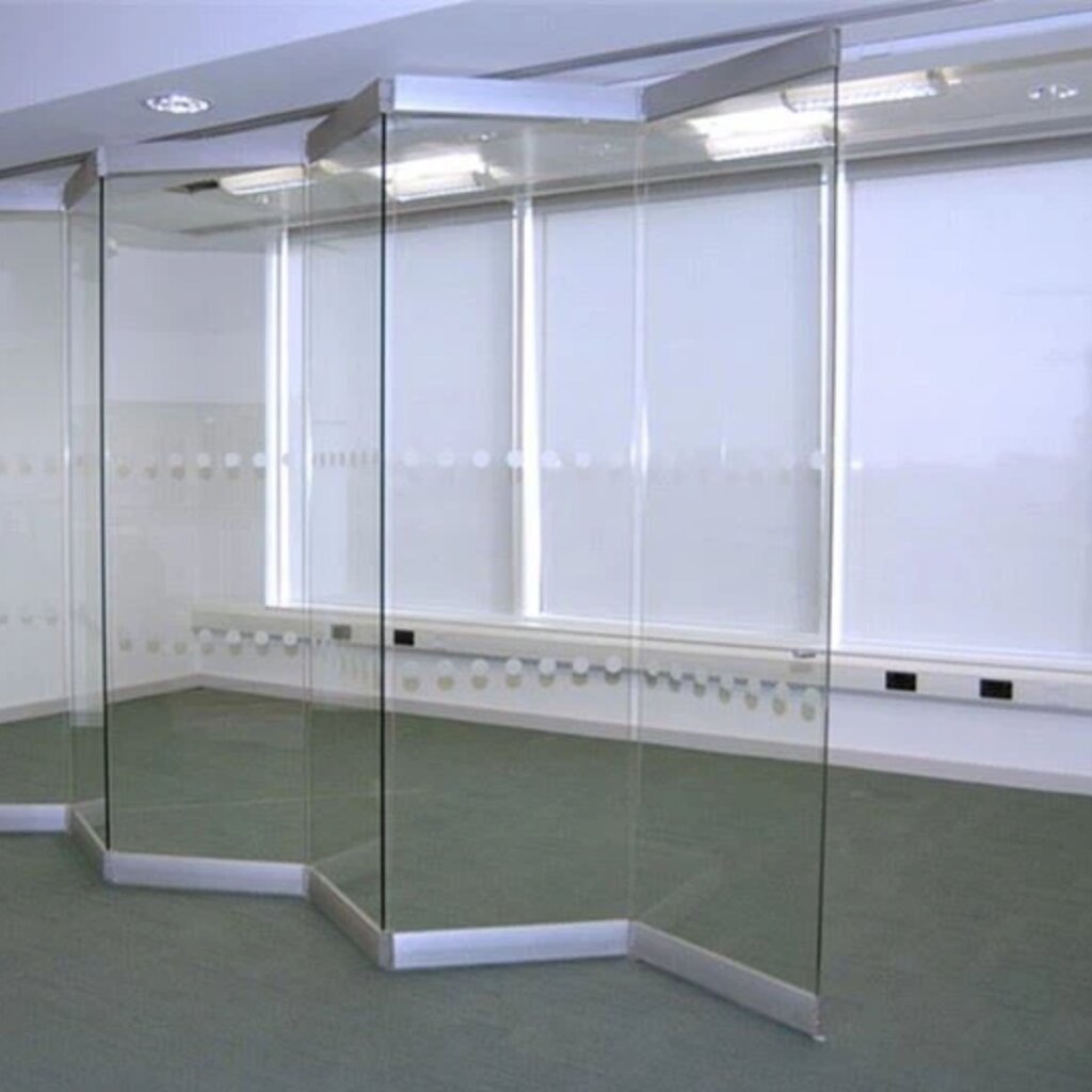 Sleek frameless folding doors in a modern office setting in Dubai, offering a contemporary and open design with glass partitions and clean lines by Elegant Rooms